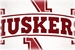 RED S/S V GLITTER NE HUSKERS AND N LOGO KINGSTON - AT-80103